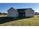 This is an image of the backyard featuring a green lawn and siding on the exterior of the home at 39 Flatland Dr, Princeton, NC 27569