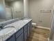 Bathroom with dual sinks, granite countertop, and a glass-enclosed shower for a modern feel at 39 Flatland Dr, Princeton, NC 27569