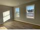 Bright bedroom with two large windows and wood-look flooring, filled with natural light at 39 Flatland Dr, Princeton, NC 27569