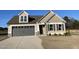 Charming tan home with a gray garage door, dormer window, and a well-manicured lawn at 39 Flatland Dr, Princeton, NC 27569