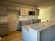 Kitchen with a breakfast bar, granite countertops, stainless steel microwave, and a decorative backsplash at 39 Flatland Dr, Princeton, NC 27569