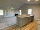 Open-concept kitchen with granite countertops, stainless steel sink, and a breakfast bar at 39 Flatland Dr, Princeton, NC 27569