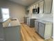 Modern kitchen showcasing granite counters, stainless steel microwave, and stylish backsplash at 39 Flatland Dr, Princeton, NC 27569