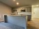 Kitchen with a breakfast bar, granite countertops, stainless steel microwave, and open doorway at 39 Flatland Dr, Princeton, NC 27569