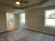 Serene main bedroom with tray ceiling, ceiling fan, and an en-suite bathroom entrance at 39 Flatland Dr, Princeton, NC 27569