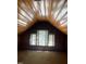 Sunlit attic features a wooden ceiling, bright window and tan carpeting at 405 N Massey St, Selma, NC 27576