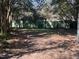 Spacious backyard featuring mature trees, a wooden fence, and a lush lawn creating a private outdoor space at 405 N Massey St, Selma, NC 27576