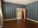 Spacious room features charming wallpaper, hardwood floors, and closet access for ample storage at 405 N Massey St, Selma, NC 27576