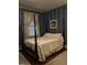Charming bedroom with four-poster bed and patterned wallpaper at 405 N Massey St, Selma, NC 27576