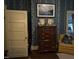 Bedroom with classic wooden dresser and floral wallpaper at 405 N Massey St, Selma, NC 27576