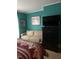 Bright bedroom features a bed, sofa, and dresser at 405 N Massey St, Selma, NC 27576