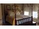 Bedroom with a four-poster bed, decorative pillows, and natural light at 405 N Massey St, Selma, NC 27576