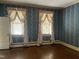 Empty bedroom with classic wallpaper and decorative windows at 405 N Massey St, Selma, NC 27576