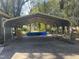 Large carport for parking vehicles or other equipment with a concrete floor and metal roof at 405 N Massey St, Selma, NC 27576