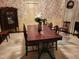 Charming dining room with a dark wood table, decorative cabinet, and floral wallpaper at 405 N Massey St, Selma, NC 27576
