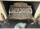 Close up of an ornate antique coal-burning fireplace with decorative iron and a metal cat sculpture at 405 N Massey St, Selma, NC 27576