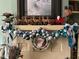 Holiday mantel decor featuring decorative ornaments, a Santa figurine and reindeer decorations on a brick mantel at 405 N Massey St, Selma, NC 27576