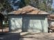 Detached one-car garage with a roll up door and full of leaves on the roof at 405 N Massey St, Selma, NC 27576