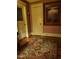 Hallway with hardwood floors, an area rug, and painted walls creating a charming and inviting atmosphere at 405 N Massey St, Selma, NC 27576