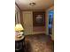 Hallway featuring hardwood floors, soft pink walls, ornate trim and a large framed painting at 405 N Massey St, Selma, NC 27576