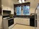 Functional kitchen with white cabinets, black countertops, and modern appliances at 405 N Massey St, Selma, NC 27576