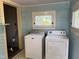 Functional laundry room with washer, dryer, and natural light at 405 N Massey St, Selma, NC 27576