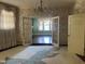 Bright living room with unique rug, chandelier, open doorway to another room, and floral wallpaper at 405 N Massey St, Selma, NC 27576