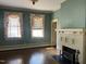 Bright living room with fireplace, windows, and hardwood flooring at 405 N Massey St, Selma, NC 27576