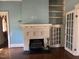 Bright room featuring a fireplace, built-in shelving, and a doorway at 405 N Massey St, Selma, NC 27576