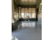 Comfortable screened-in front porch with painted wood floors and brick columns and a view of the street at 405 N Massey St, Selma, NC 27576