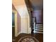 Classic staircase featuring hardwood steps, painted risers, and unique decor creating a cozy and traditional ambiance at 405 N Massey St, Selma, NC 27576