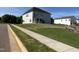 Newly sodded back yard showing a side view of the home, sidewalk and neighboring houses at 4302 Emeline Way # 16, Fuquay Varina, NC 27526