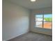 Carpeted bedroom featuring a large window that lets in natural light at 4302 Emeline Way # 16, Fuquay Varina, NC 27526