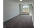 Comfortable bedroom offers neutral carpet and a large window overlooking the front yard at 4302 Emeline Way # 16, Fuquay Varina, NC 27526