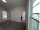 Bright bedroom with neutral carpet, white walls, and large window offering ample natural light at 4302 Emeline Way # 16, Fuquay Varina, NC 27526