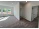 Bright bedroom featuring large windows, neutral carpet, and white walls for a modern feel at 4302 Emeline Way # 16, Fuquay Varina, NC 27526