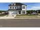 Two-story home features a gray exterior, dormer windows, a black roof, an attached garage, and a manicured lawn at 4302 Emeline Way # 16, Fuquay Varina, NC 27526