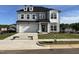 Beautiful two-story home with a well-manicured lawn, a two-car garage, and elegant architectural details at 4302 Emeline Way # 16, Fuquay Varina, NC 27526