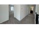 View of neutral carpeted hallway with views into a bedroom and a bathroom at 4302 Emeline Way # 16, Fuquay Varina, NC 27526