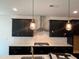 The kitchen has sleek, dark cabinetry, stainless steel appliances and a modern design at 4302 Emeline Way # 16, Fuquay Varina, NC 27526