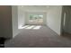 Bright living room features neutral carpet and ample natural light from a row of large windows at 4302 Emeline Way # 16, Fuquay Varina, NC 27526