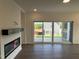 Open-concept living room featuring a fireplace, luxury vinyl plank flooring, and a sliding door to a patio at 4302 Emeline Way # 16, Fuquay Varina, NC 27526