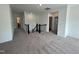 Open loft area with neutral carpet features a staircase with black iron spindles at 4302 Emeline Way # 16, Fuquay Varina, NC 27526