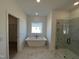 Bright bathroom boasts a modern free-standing tub and a separate glass shower enclosure at 4302 Emeline Way # 16, Fuquay Varina, NC 27526