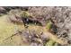 Aerial view of the property's vast land and wooded surroundings, barn, and vehicles at 4775 Barber Mill Rd, Clayton, NC 27520