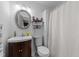 Cozy bathroom with silver framed mirror, vanity, and shower featuring white waffle curtain at 4775 Barber Mill Rd, Clayton, NC 27520