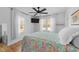 Bright bedroom with hardwood floors, ceiling fan, and vibrant, colorful quilt at 4775 Barber Mill Rd, Clayton, NC 27520