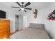 Comfortable bedroom featuring hardwood floors, a ceiling fan, and neutral decor at 4775 Barber Mill Rd, Clayton, NC 27520