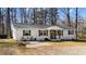 Ranch-style home with a brick facade, decorative shutters and welcoming front patio at 4775 Barber Mill Rd, Clayton, NC 27520