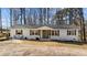 Charming ranch-style home with a brick facade, green door, and inviting front porch at 4775 Barber Mill Rd, Clayton, NC 27520